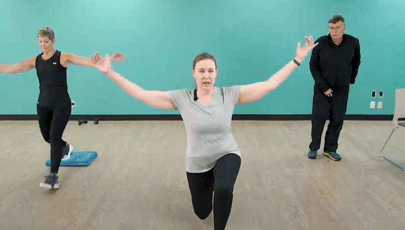 Three people in an exercise class