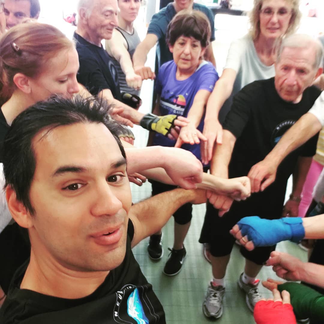 A group of people holding their fists together