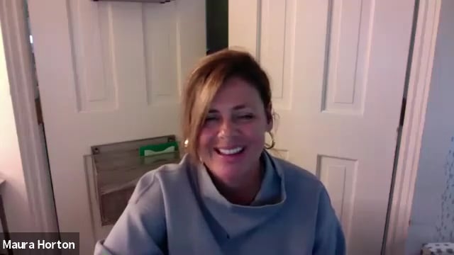 A woman smiling on a video call