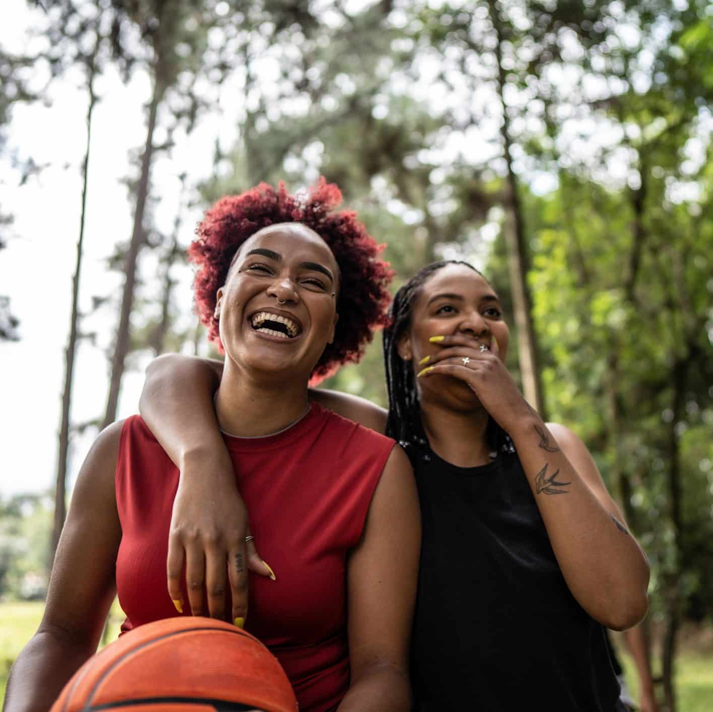 Basketball female friends walking on a public park