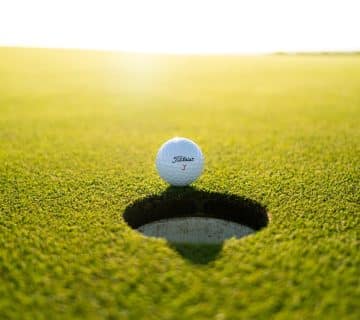golf ball on green grass field during daytime