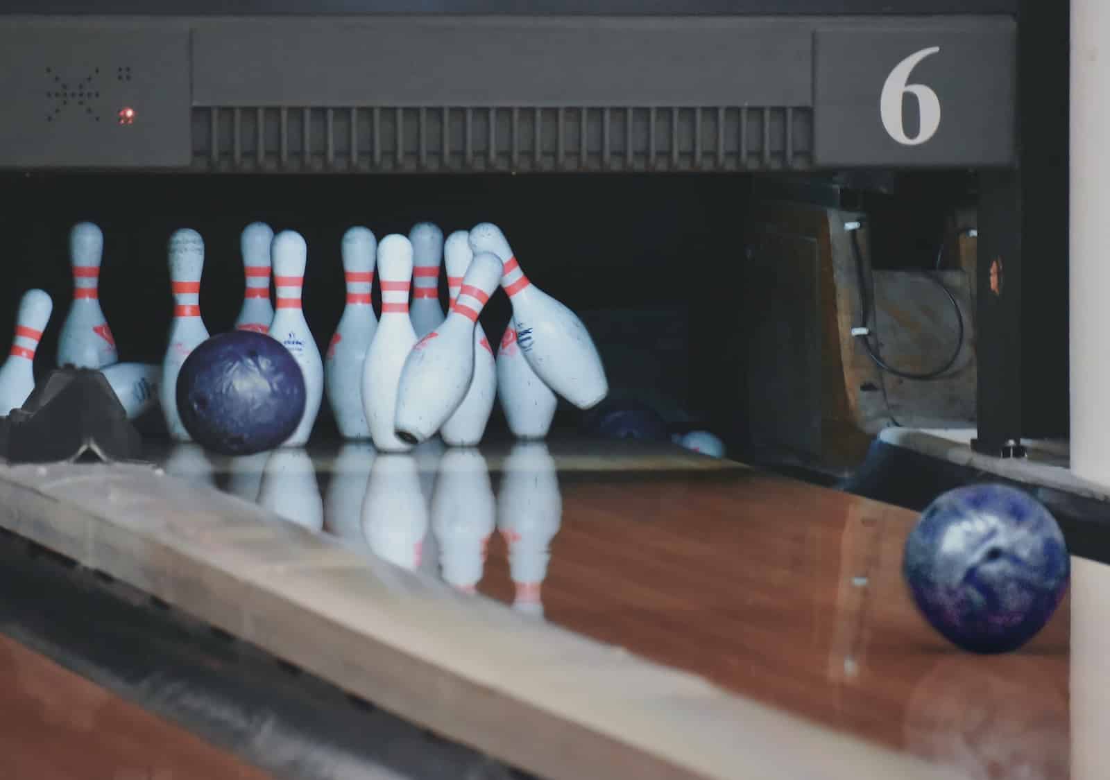 Bowling balls striking down pins