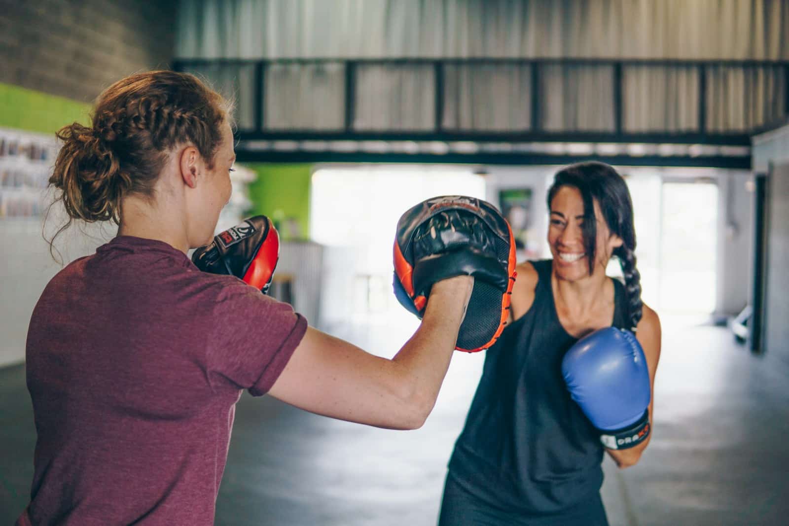 woman in red t-shirt wearing boxing gloves